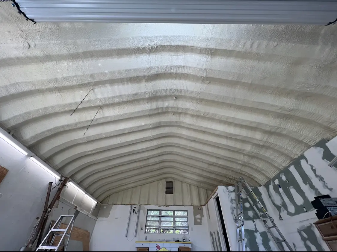 Spray polyurethane foam applied to the underside of a metal roof deck in Greenfield